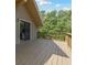 Exterior image of the home showing a wooden balcony with view of trees and the roofline at 7606 Four Pines Rd, Plant City, FL 33565