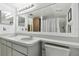 Bathroom featuring a double sink vanity with lots of counter space and a large mirror at 7606 Four Pines Rd, Plant City, FL 33565