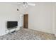 Minimalist bedroom featuring white walls, ceiling fan and door to hallway at 7606 Four Pines Rd, Plant City, FL 33565