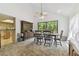 Bright dining room featuring vaulted ceiling, ceiling fan, and an antique wood china cabinet at 7606 Four Pines Rd, Plant City, FL 33565