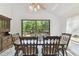 Bright dining room featuring vaulted ceiling, wood table with floral arrangement, and antique wood cabinet at 7606 Four Pines Rd, Plant City, FL 33565