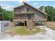 Inviting stilt home with double porches, accessed by exterior staircase at 7606 Four Pines Rd, Plant City, FL 33565