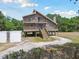 Inviting stilt home with double porches, accessed by exterior staircase at 7606 Four Pines Rd, Plant City, FL 33565