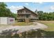 Inviting stilt home with double porches, accessed by exterior staircase at 7606 Four Pines Rd, Plant City, FL 33565