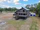 Two-story elevated coastal home with wraparound decks and screened porch on spacious lot at 7606 Four Pines Rd, Plant City, FL 33565