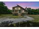 Charming home with elevated wraparound porch, blending with the surrounding trees at 7606 Four Pines Rd, Plant City, FL 33565