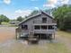 Two-story coastal home with decks and screened porch, blending living spaces with the surrounding nature at 7606 Four Pines Rd, Plant City, FL 33565