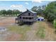 Two-story coastal home with wraparound decks, screened porch, and convenient storage containers on property at 7606 Four Pines Rd, Plant City, FL 33565