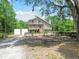 Charming stilt home features a dual-level porch and natural surroundings at 7606 Four Pines Rd, Plant City, FL 33565