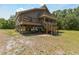 Stunning exterior view of the raised home featuring multilevel decks for outdoor enjoyment at 7606 Four Pines Rd, Plant City, FL 33565