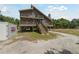 Inviting stilt home with double porches, accessed by exterior staircase at 7606 Four Pines Rd, Plant City, FL 33565