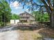 Charming stilt home features a dual-level porch and natural surroundings at 7606 Four Pines Rd, Plant City, FL 33565