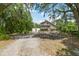 Charming stilt home features a dual-level porch and natural surroundings at 7606 Four Pines Rd, Plant City, FL 33565