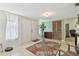 Welcoming foyer featuring a floral area rug, tiled floor, a large storage closet, and a decorative potted tree at 7606 Four Pines Rd, Plant City, FL 33565