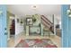 Entryway with tiled floor, stairs, and open access to living spaces, creating a welcoming first impression at 7606 Four Pines Rd, Plant City, FL 33565