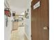Hallway view leading to a kitchen with wooden cabinets at 7606 Four Pines Rd, Plant City, FL 33565
