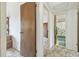 Hallway view into bathroom with decorative shower curtain and blue bath mat at 7606 Four Pines Rd, Plant City, FL 33565