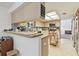 Bright kitchen with ample counter space, light wood cabinetry, and a functional island, perfect for cooking at 7606 Four Pines Rd, Plant City, FL 33565