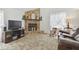 Cozy living room showcasing a stone fireplace, soft carpet, and comfortable seating arrangement at 7606 Four Pines Rd, Plant City, FL 33565