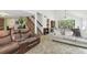 Cozy living room featuring comfortable seating and access to a dining area, perfect for Gathering gatherings and relaxation at 7606 Four Pines Rd, Plant City, FL 33565
