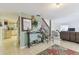 Inviting living space with neutral flooring, a decorative mirror, and easy access to the kitchen and stairway at 7606 Four Pines Rd, Plant City, FL 33565