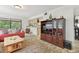 Cozy living room with a large entertainment center and comfortable red sofa at 7606 Four Pines Rd, Plant City, FL 33565