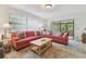 Comfortable living room with large windows, plush seating, and neutral flooring, creating a warm and inviting space at 7606 Four Pines Rd, Plant City, FL 33565