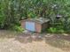 View of detached garage with a wooden structure and light blue garage door at 7606 Four Pines Rd, Plant City, FL 33565