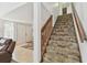 View of the stairway leading to the upper level of the home, located just off the main entrance foyer at 7606 Four Pines Rd, Plant City, FL 33565