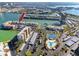 Waterfront condo building featuring tennis courts, a marina, and covered parking at 7645 Sun Island S Dr # 304, South Pasadena, FL 33707