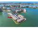 Waterfront condo building featuring assigned covered parking, a pool, and tennis courts at 7645 Sun Island S Dr # 304, South Pasadena, FL 33707