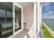 Balcony with railing overlooks waterfront views and has tile flooring at 7645 Sun Island S Dr # 304, South Pasadena, FL 33707