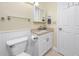 Bathroom features a white vanity with a granite countertop and a mirrored medicine cabinet at 7645 Sun Island S Dr # 304, South Pasadena, FL 33707