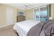 Comfortable bedroom with ceiling fan, dresser, waterfront view, and natural light at 7645 Sun Island S Dr # 304, South Pasadena, FL 33707
