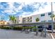 Exterior view of The Saratoga building with covered parking and bike racks for convenient community living at 7645 Sun Island S Dr # 304, South Pasadena, FL 33707