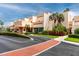 Modern condo exterior with manicured landscaping, palm trees, and well-maintained facade under a bright blue sky at 7645 Sun Island S Dr # 304, South Pasadena, FL 33707