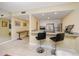 View of the kitchen from the living room with breakfast bar and stainless steel appliances at 7645 Sun Island S Dr # 304, South Pasadena, FL 33707