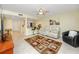 Inviting living room features tile floors, a ceiling fan, and a view of the kitchen with bar seating at 7645 Sun Island S Dr # 304, South Pasadena, FL 33707