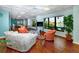 Inviting lounge area with comfortable seating, a TV, and scenic water views through large windows at 7645 Sun Island S Dr # 304, South Pasadena, FL 33707