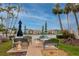 Outdoor seating area with tables and umbrellas overlooking the water, perfect for entertaining at 7645 Sun Island S Dr # 304, South Pasadena, FL 33707