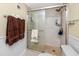 Bathroom features a shower with a glass door and a tile surround at 7645 Sun Island S Dr # 304, South Pasadena, FL 33707