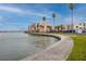 Beautiful waterfront view of the community on a sunny day, with adjacent sidewalk at 7645 Sun Island S Dr # 304, South Pasadena, FL 33707