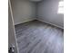 Bedroom featuring modern flooring, neutral walls, and natural light at 8440 Old Post Rd # 104, Port Richey, FL 34668