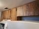 Kitchen cabinets with a modern hood, clean white appliance, and dark hardware at 8440 Old Post Rd # 104, Port Richey, FL 34668
