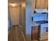 Kitchen area featuring sleek flooring, white appliances, and fresh paint at 8440 Old Post Rd # 104, Port Richey, FL 34668