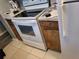Kitchen features a white stove, updated cabinets, and a light tile floor at 8440 Old Post Rd # 104, Port Richey, FL 34668