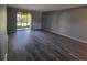 Living room showcasing modern flooring, neutral walls, and a glass sliding door at 8440 Old Post Rd # 104, Port Richey, FL 34668