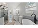 Bathroom boasting a soaking tub, walk-in shower, and stylish vanity at 9375 French Quarters Cir, Weeki Wachee, FL 34613