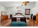 Cozy bedroom features vaulted ceiling, decorative quilt and ceiling fan at 9375 French Quarters Cir, Weeki Wachee, FL 34613