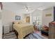 Cozy bedroom with a ceiling fan, wood floors, and a window with plantation shutters at 9375 French Quarters Cir, Weeki Wachee, FL 34613